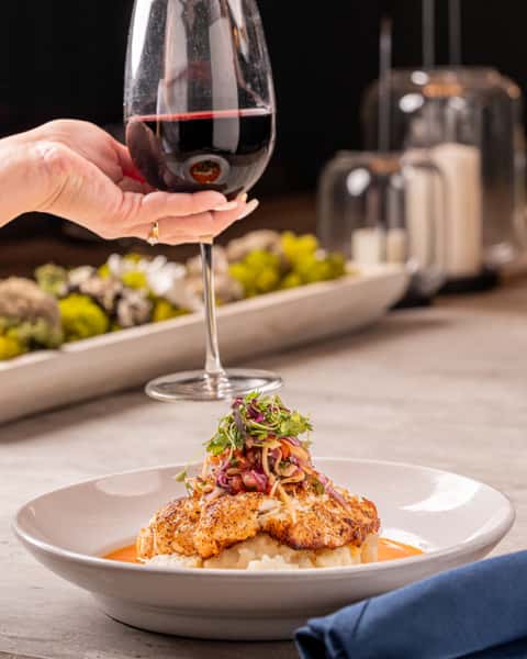 person with wine and entree