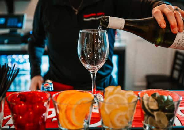friendly server pouring wine