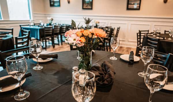 expansive seating for up to 50 people with elegant black linens