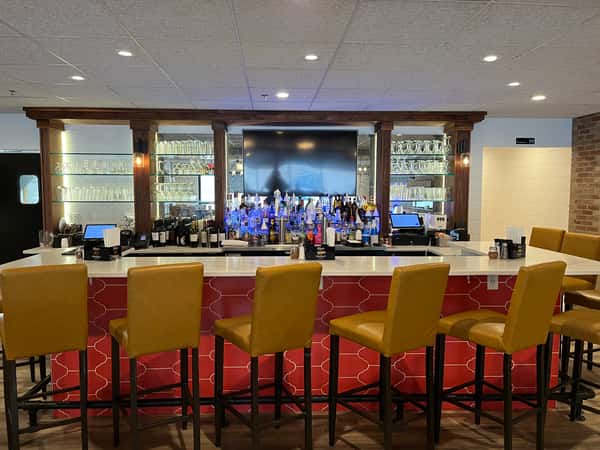 Hanover Mamma Mia's bar, red tile, white marble, tan leather chairs, television, clean, well-lit space
