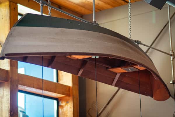 vintage wooden boat hanging from ceiling