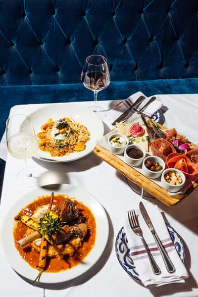 Plates of food and drinks from Enoteca Rossa on a table