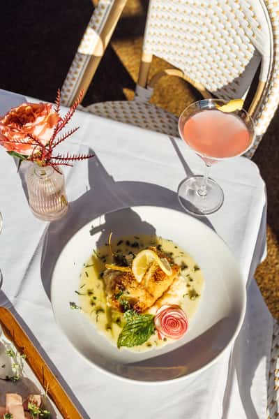 Plated seafood dish with a cocktail