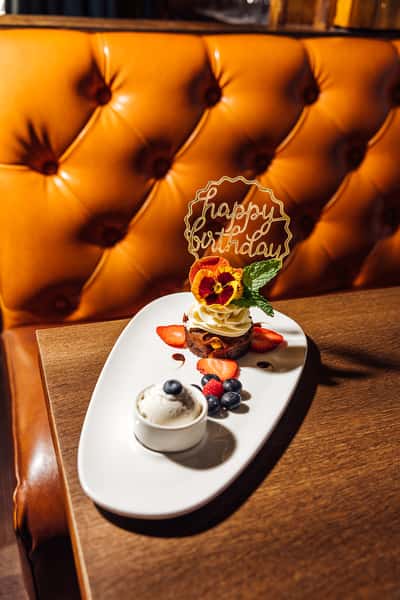 Happy Birthday dessert with fresh berries and cream