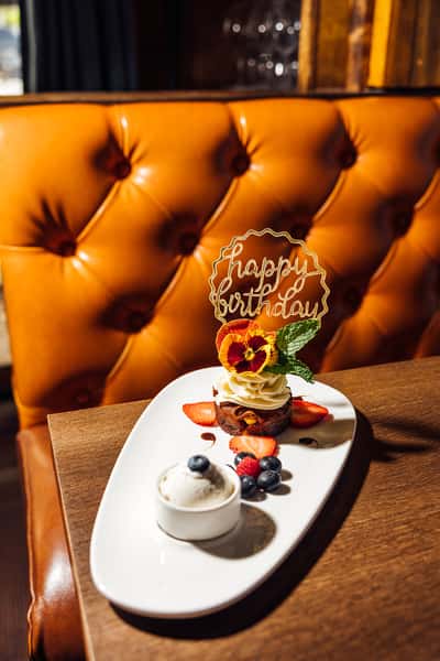 Happy Birthday dessert with fresh berries and cream
