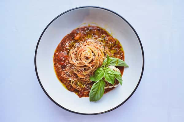 San Marzano tomato pomodoro sauce tossed with al dente spaghetti, finished with roasted garlic, extra virgin olive oil, and shaved Parmesan. A vibrant, vegetarian-friendly staple on the Osteria Italian Seafood dinner menu.