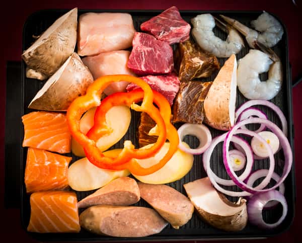 A variety of meats and veggies on a tray
