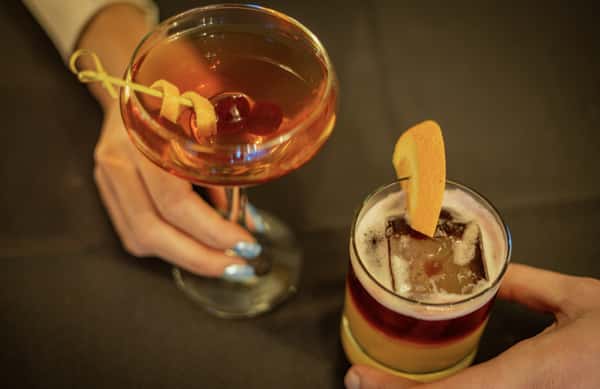 Two specialty cocktails on a table