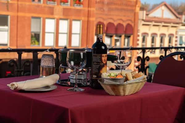 A dining table with wine, bread and fondue