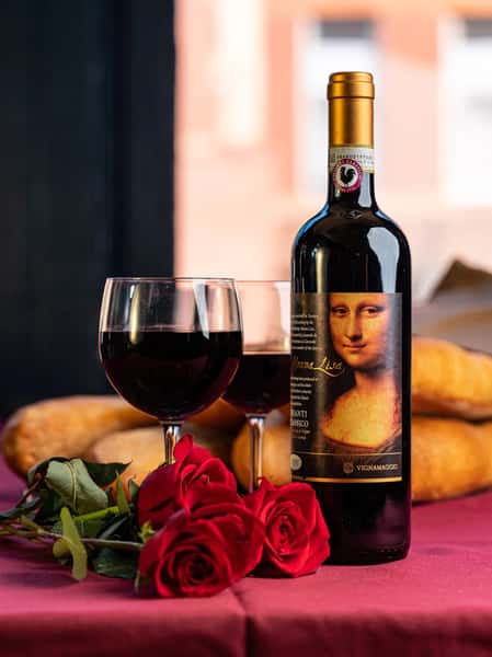 Two wine glasses with a bottle of red wine