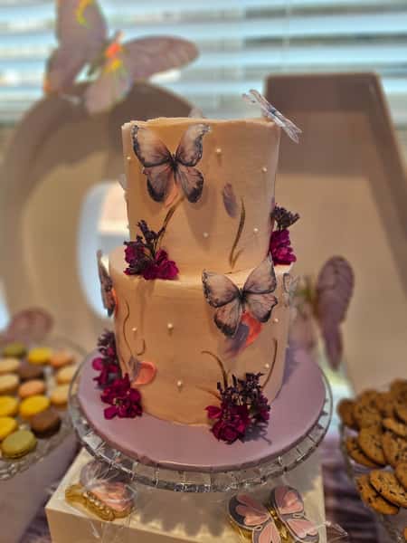 pink cake with flowers and butterflies