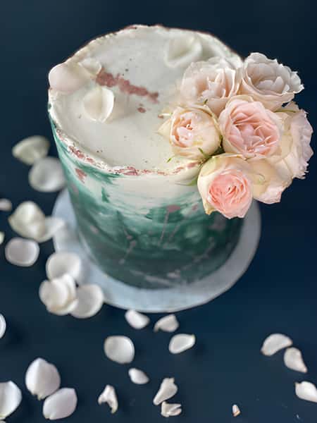 marble frosted cake topped with roses