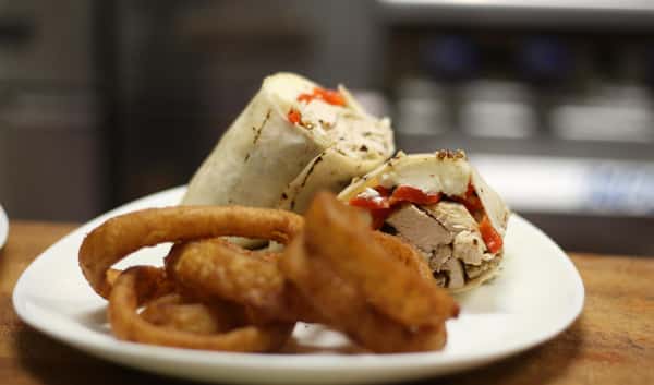 Grilled Chicken, Red peppers, Fresh Mozzarella in a Wrap, with onion rings.