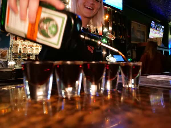 bartender filling shot glasses