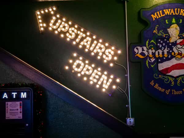 lighted sign "Upstairs Open"