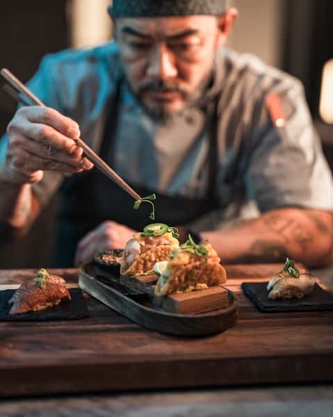 Chef decorating a food plate