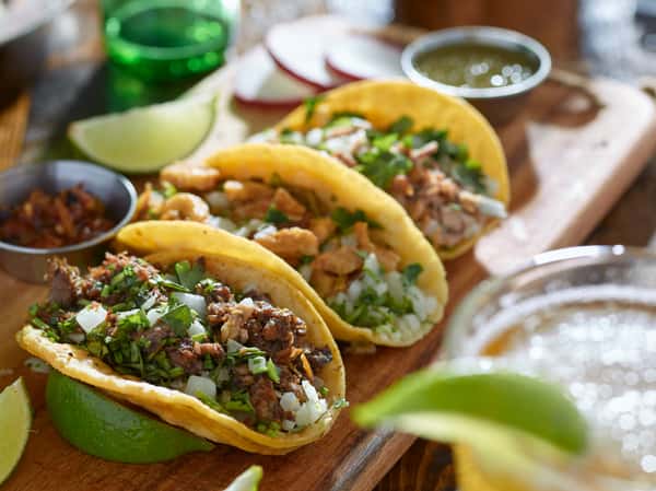 Filled and seasoned tacos with garnish