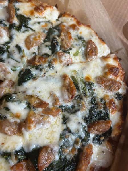 Pizza with sausage and spinach