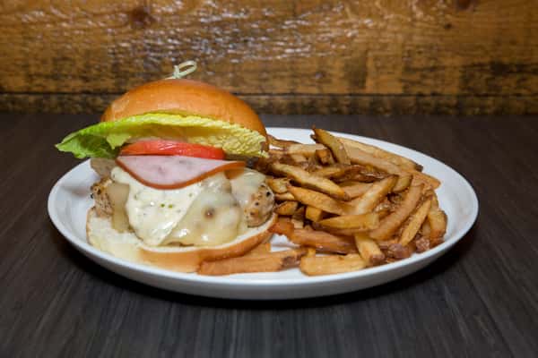 A classic burger stacked with melted cheese, lettuce, and tomato on a toasted bun, served with a generous side of crispy fries. It's a hearty, all-American favorite presented in a simple, inviting way.