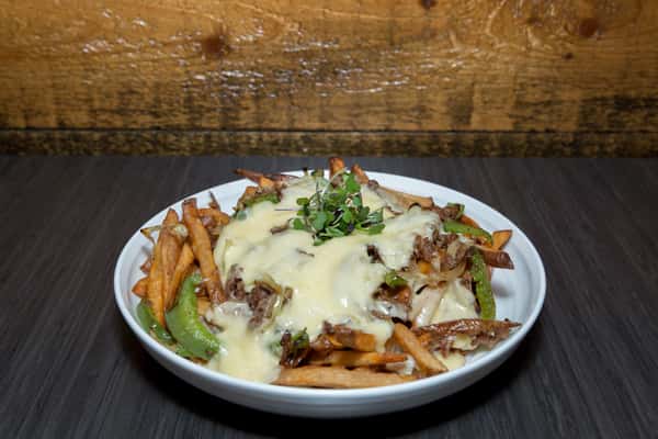 This dish features a entrée topped with a rich, creamy sauce, served over a bed of roasted vegetables and crispy potatoes. Fresh herbs add a touch of brightness, balancing the comforting and savory flavors.