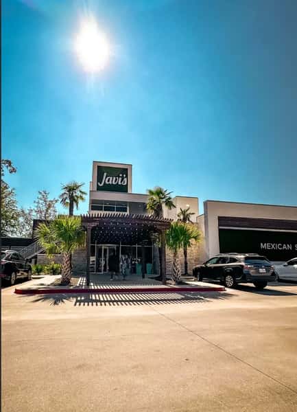 Javi's Mexican restaurant exterior with modern design, palm trees, and sunny Texas sky creating a welcoming dining atmosphere