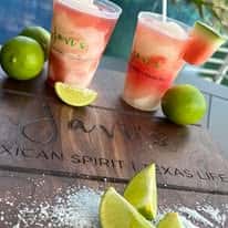 Watermelon margaritas with lime garnish and salt, refreshing patio drinks at Mexican restaurant