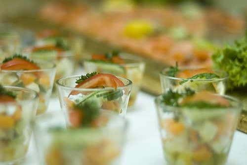 mini shot glasses filled with tomatoes, cucumbers and lettuce