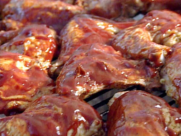 bbq chicken with sauce on a grill