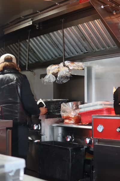chef cooking inside food truck
