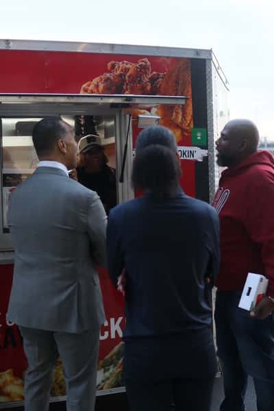 people waiting for food at food truck