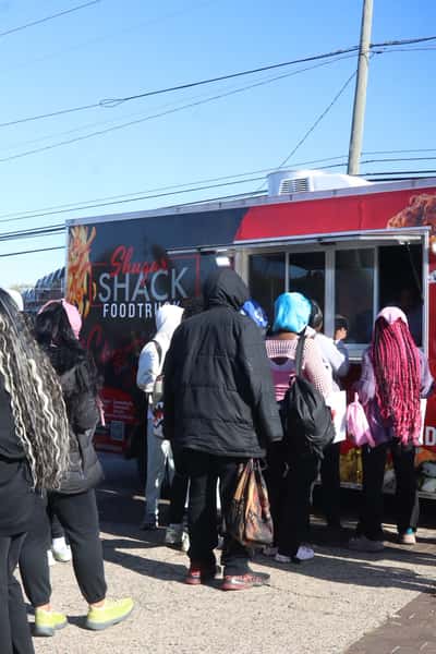 people waiting in line for food truck