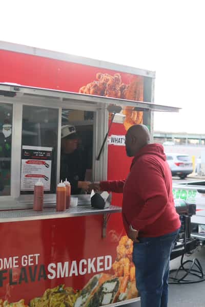 man ordering at food truck