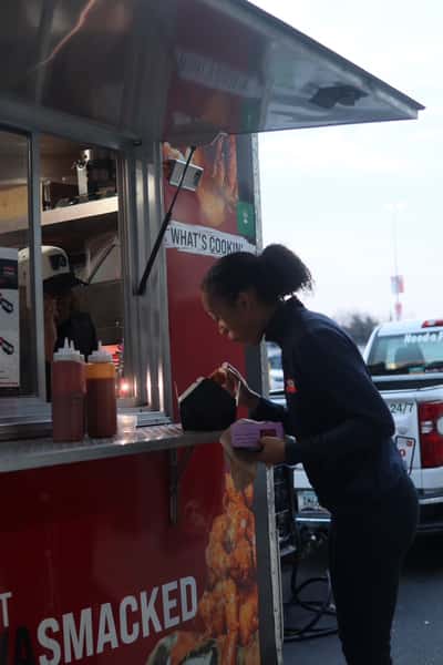 person receiving food at food truck