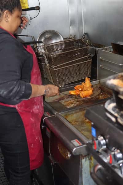 chef frying food inside food truck