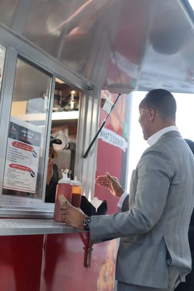 man in suit ordering at food truck