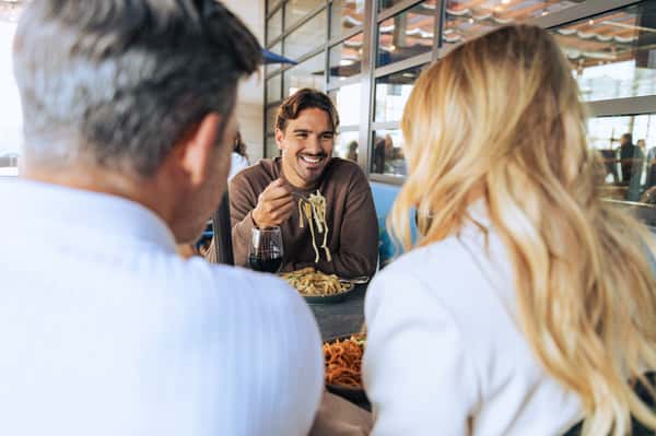 Three guests enjoying pasta