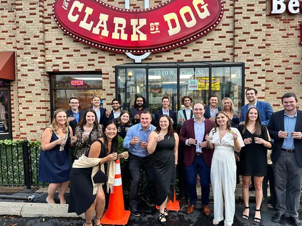 Guests at a Lakeview event enjoying catering from Clark Street Dog.
