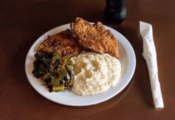 Fried fillets with creamy grits and collard greens.