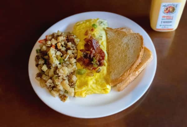 Breakfast plate with veggie omelet, potatoes, and toast.