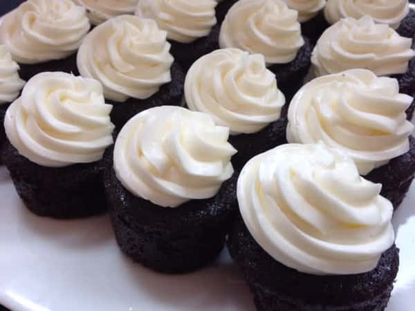 Mini chocolate cupcakes with vanilla buttercream frosting.