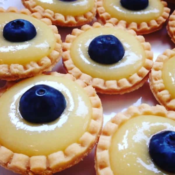 Mini tarts topped with fresh blueberries.