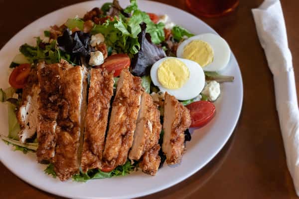 Crispy chicken Cobb salad with eggs, bacon, tomatoes, and blue cheese.