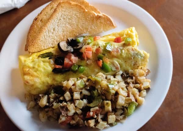 Veggie omelet with home potatoes and toast.
