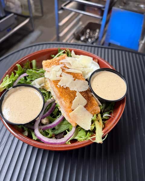 Cajun Salmon Salad is a customer favorite for a reason 🥗 Roasted salmon, bacon, egg, red onion & parmesan come together with creamy Cajun vinaigrette for a bold, satisfying bite in every forkful. Stop by Colorado Grille - Best Burgers in the San Luis Valley and see why Cajun Salmon Salad keeps guests coming back. 😋 #CajunSalmonSalad #ColoradoGrille #CustomerFavorite