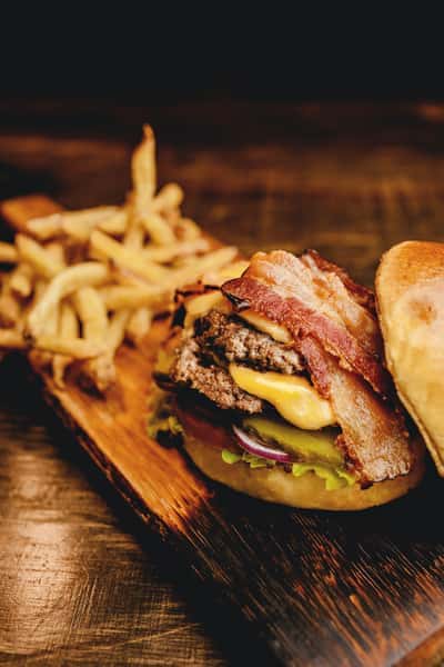 Double burger with a variety of toppings and french fries