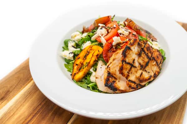 heirloom tomatoes, arugula, basil pesto, and bocconcini, tossed in a balsamic vinaigrette, topped with parmesan crusted chicken breast served over a grilled ciabatta.
