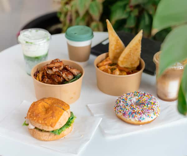Several menu items displayed on a table, from coffee to donuts, bagels and heartymeals.