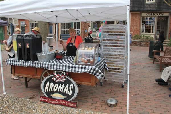 table set up outside with the aromas logo under it