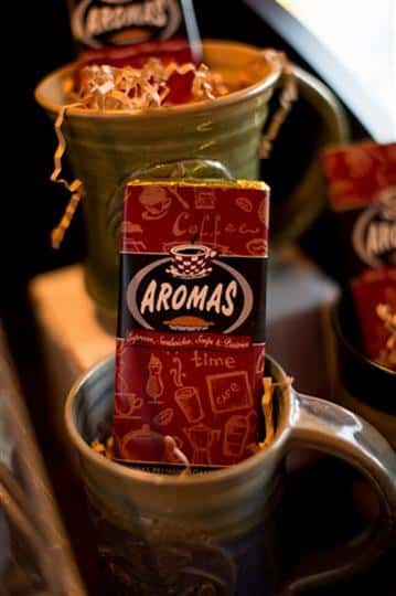 coffee cup with chocolate bar inside with the aromas logo