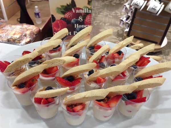 tray of cups filled with fruit and biscotti